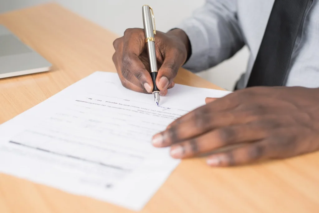 a man is signing a document