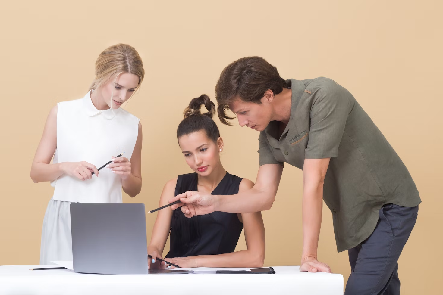man pointing laptop to women